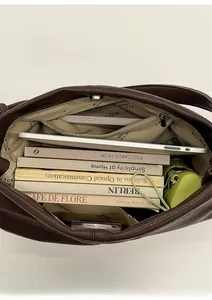 Detailed interior of large leather tote bag showing spacious capacity for books and tablet
