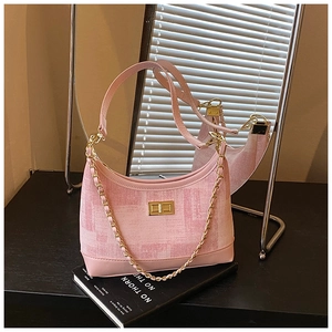 Detailed close-up of pink hobo bag with gold twist lock and chic metal chain