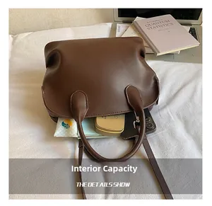 Top-down view of spacious dark brown handbag interior holding phone and daily essentials