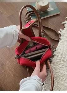 Top view of red canvas tote bag interior with brown leather trim and spacious compartments