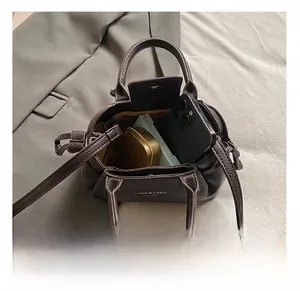 Internal view of the brown leather mini square bag showing spacious main compartment