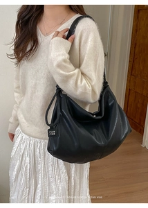 Minimalist large black leather tote bag with PAN TOR logo tag and soft vintage texture