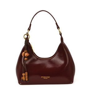 Deep red oily leather crescent hobo bag with glossy finish and retro wooden bead charm