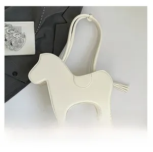 Detailed view of the white horse-shaped shoulder bag featuring a tassel tail and smooth PU