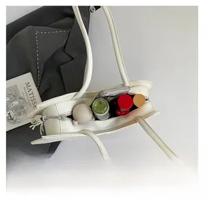 Top view of white leather tote bag interior showing spacious storage for daily essentials