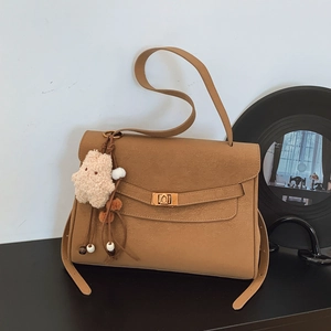 Vintage frosted brown shoulder bag with a gold twist lock and a cute plush charm