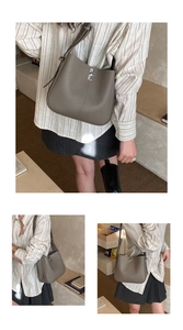 Detail view of grey litchi leather bucket bag showing silver hardware and side texture