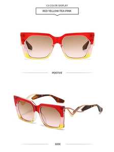 Detail of square oversized sunglasses with wavy gold metal temples and gradient lenses