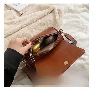 Detail showing the large interior capacity of this retro brown leather crossbody bag