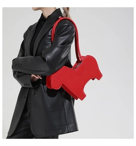 Detail of red puppy-shaped creative shoulder bag with smooth matte leather finish