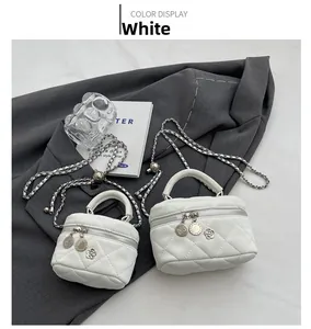 Detail of white quilted mini chain bags with floral zipper charms on a grey blazer