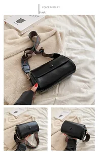 Detail of black cylindrical crossbody bag with bohemian style wide woven shoulder strap