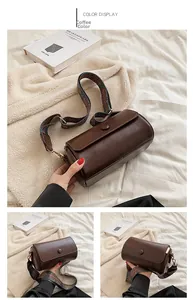 Detail of coffee brown cylinder bag featuring a bohemian embroidered wide shoulder strap