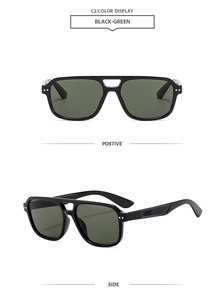 Detail of vintage double-bridge sunglasses featuring black frames and green lenses