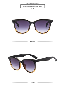Detail view of square sunglasses with black and tortoise frame and gradient lenses