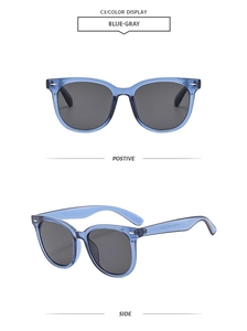 Detail of blue transparent square sunglasses with silver metal rivets and gray lenses
