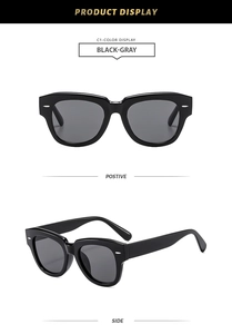 Gros plan sur des lunettes de soleil rétro noires avec rivets argentés et monture