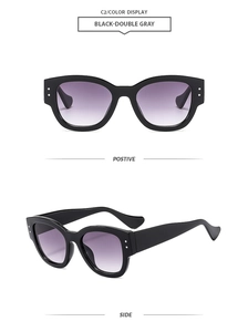 Detail view of black butterfly frame sunglasses with silver rivets and gradient lenses