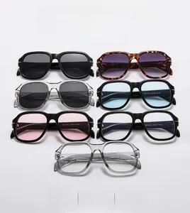 Flat lay of square oversized sunglasses in black, tortoiseshell, and transparent grey frames