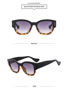 Detail of wide frame sunglasses in black and tortoiseshell with purple gradient lenses
