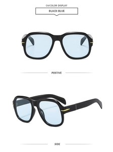 Detail of square vintage sunglasses with black frames, blue lenses, and gold arrow hinges