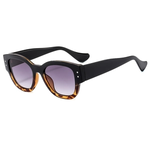 Retro black and tortoiseshell sunglasses with violet gradient lenses and silver rivets