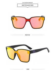 Detail view of matte black oversized sunglasses with red accents and mirrored red lenses