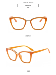 Detail view of orange cat-eye glasses frame with gold metal trim and transparent finish