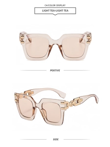 Detail of light tea square sunglasses featuring golden metal chain link temples