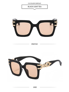 Detail of square oversized sunglasses with gold chain temples and light tea lenses