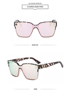 Detail view of large square tortoiseshell sunglasses with pink lenses and gold temple accents