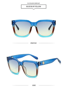 Detail of square oversized gradient sunglasses with blue to tan frames and gold metal accents