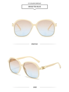 Detail of beige square sunglasses with tea blue gradient lenses and gold metal hinge