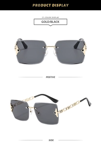 Detail of gold chain temples and rimless grey lenses on stylish metal sunglasses