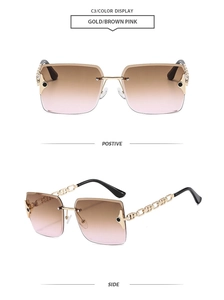 Close-up of rimless gradient lenses and gold hollow chain temples on sunglasses