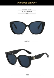 Detail view of retro cat-eye sunglasses with polished black frames and gold logo