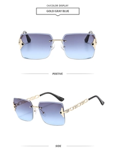 Detail of rimless oversized sunglasses with gold chain temples and gray blue lenses