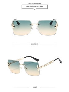 Detail of rimless square sunglasses with gold metal chain temples and green yellow lenses