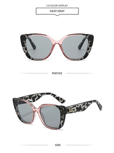 Detail view of retro cat-eye sunglasses with pink tortoiseshell frame and golden LH logo