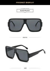 Detail view of large square oversized sunglasses in glossy black with dark grey lenses