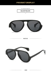 Detail of black aviator sunglasses featuring thick temples and classic retro design