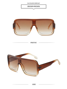 Detail view of large square brown sunglasses with gradient lenses and one-piece frame