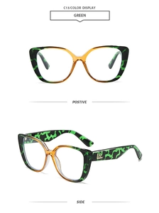 Detail view of cat-eye sunglasses featuring green camouflage and amber frames