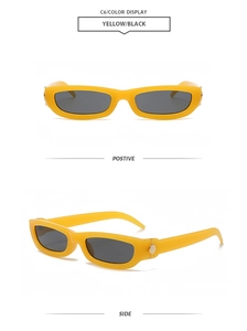 Detail view of yellow rectangle sunglasses with black lenses and gold metal hinges