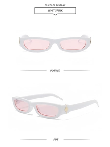 Detailed view of white narrow frame sunglasses with pink lenses and gold metal accents
