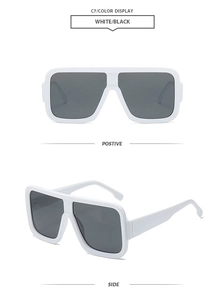 Detail view of white square oversized sunglasses with dark lenses from front and side angles