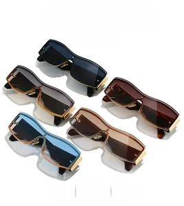 Flat lay of rimless rectangular sunglasses in multiple colors with gold metal temples