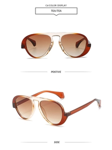Detail view of tea-colored pilot sunglasses with gradient lenses and a vintage frame