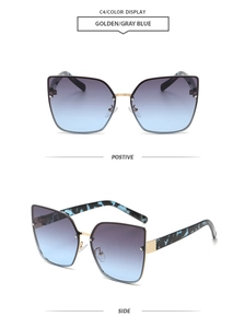 Detail view of rimless cat-eye sunglasses with golden metal and blue-grey gradient lenses