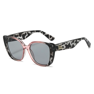 Retro cat-eye sunglasses with marble pattern frames and gold H logo detail